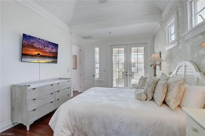 Bedroom featuring wood ceiling, vaulted ceiling, dark hardwood / wood-style flooring, french doors, and access to outside