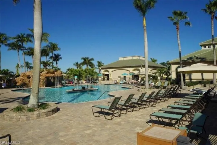 Community pool with a patio area and a gazebo