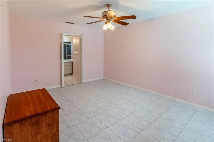 Unfurnished room with a ceiling fan and light tile patterned floors