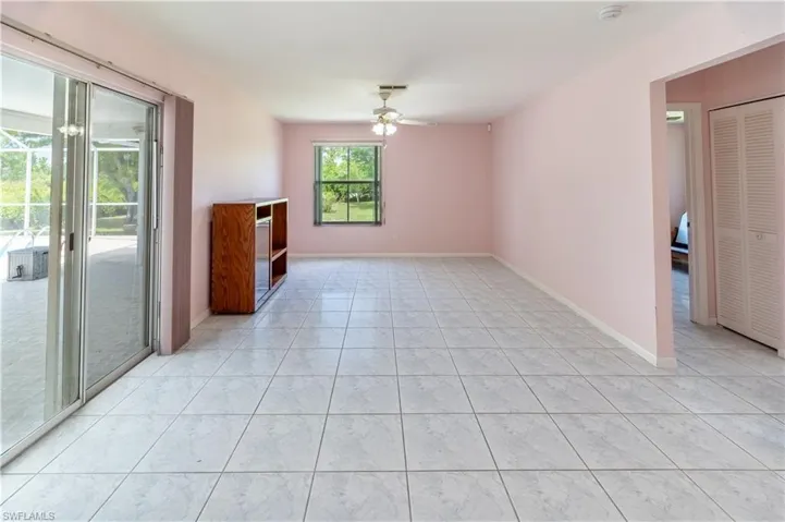Unfurnished room with a ceiling fan and light tile patterned flooring