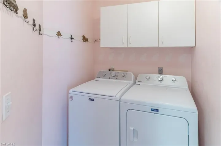 Laundry room with cabinet space and washing machine and clothes dryer