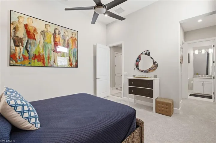 Carpeted room featuring a ceiling fan, white walls, and a recessed doorway