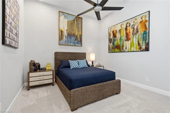 Spacious room featuring vaulted ceilings and light-toned carpeting