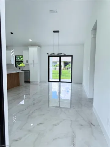 Spare room with light marble finish floors and recessed lighting