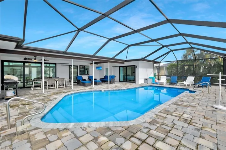 Outdoor pool featuring an outdoor living space, a sunroom, a ceiling fan, and a patio