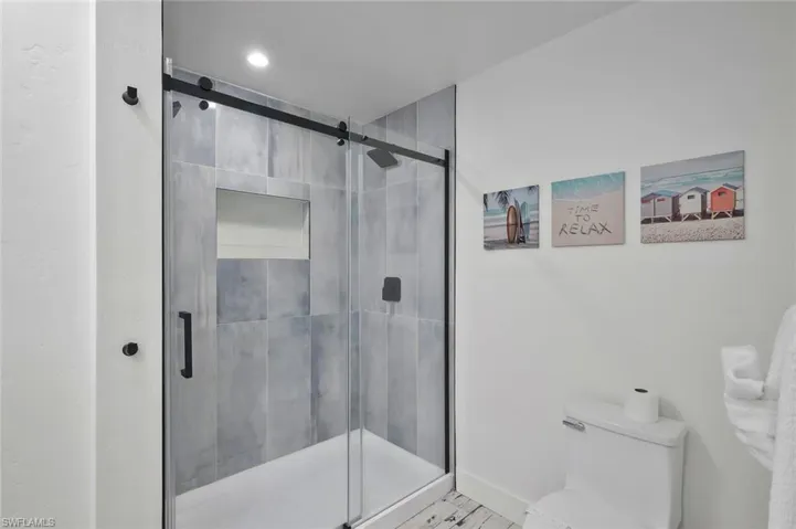 Full bath featuring a shower stall