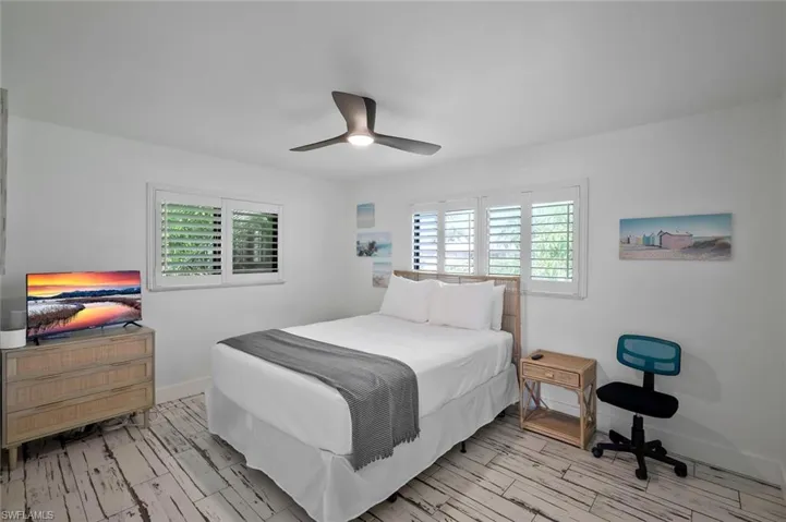 Bedroom with light wood-style floors and a ceiling fan