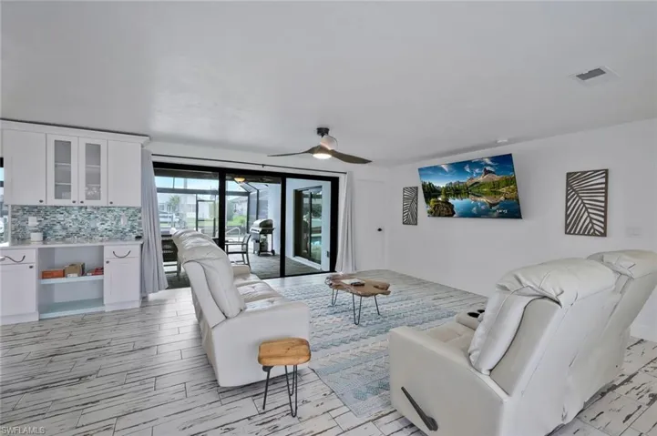 Living area featuring wood finish floors and a ceiling fan
