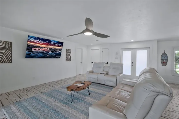Living room with wood finished floors and a ceiling fan