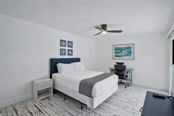 Bedroom with light wood-type flooring and a ceiling fan