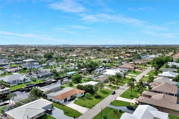 Aerial perspective of suburban area with a large body of water