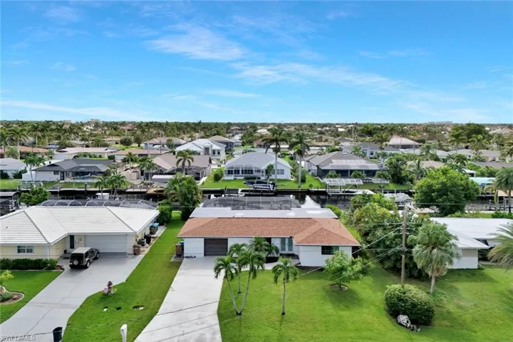 Aerial perspective of suburban area with a nearby body of water