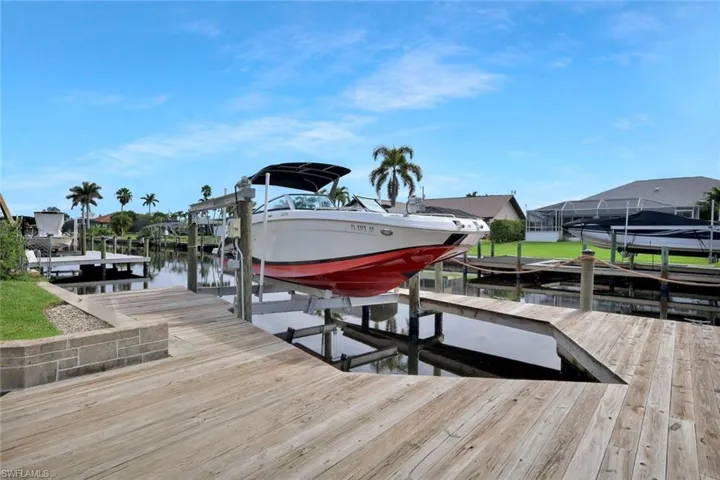 Dock featuring boat lift and a water view