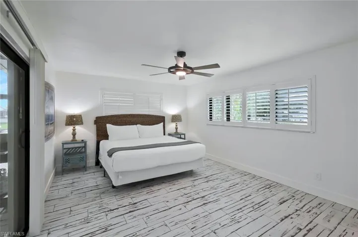 Bedroom featuring wood tiled floors and ceiling fan