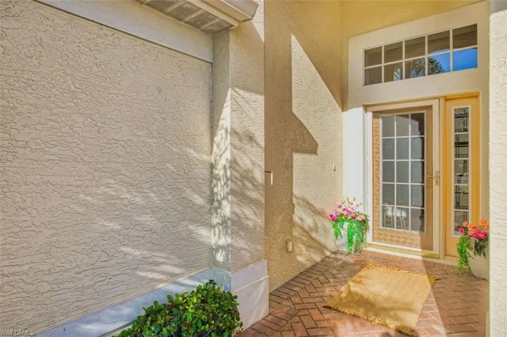 Doorway to property with stucco siding