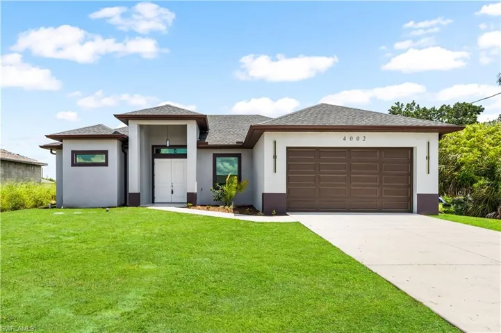 Contemporary exterior with a double-door entry, a two-car garage, and a concrete driveway