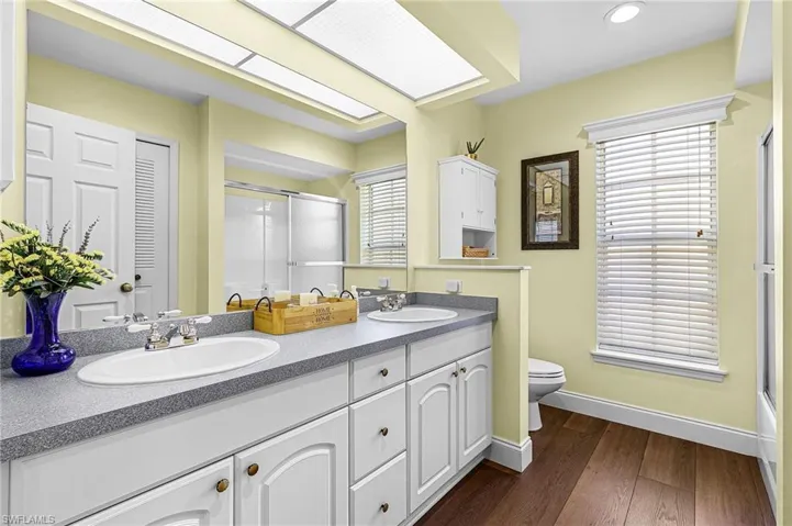 The guest bathroom has tub/shower combination, dual sinks, and large linen closet for extra storage