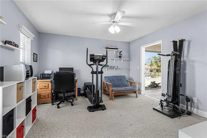 The guest room has a huge walk-in closet, carpet and door opens to the screened lanai