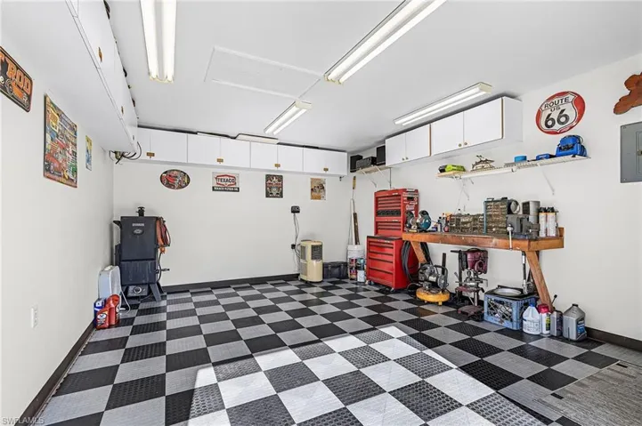 .  The 2-car garage is also immaculate! It has a side door that exits to a large, graveled area between home and the detached BONUS workshop.  This dream workshop-man cave has a single door, a roll up door, and storage cabinets, checkerboard foam flooring pads, and lots of lighting.