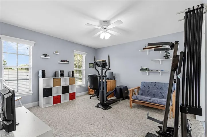 The guest room has a huge walk-in closet, carpet and door opens to the screened lanai