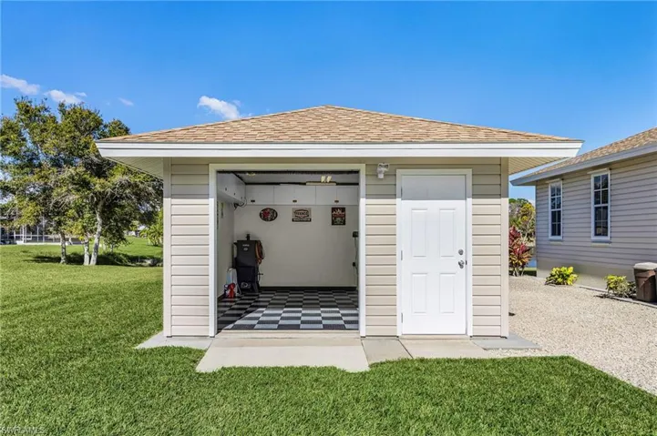 .  The 2-car garage is also immaculate! It has a side door that exits to a large, graveled area between home and the detached BONUS workshop.  This dream workshop-man cave has a single door, a roll up door, and storage cabinets, checkerboard foam flooring pads, and lots of lighting.