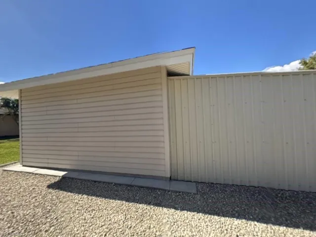 Just behind the detached workshop is a large metal shed for additional storage space and is where the hurricane shutters are stored