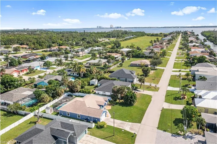 Aerial view of residential area featuring a nearby body of water