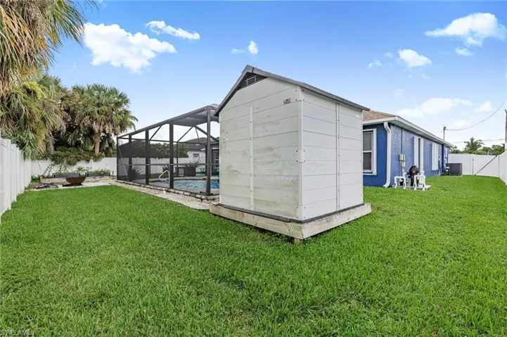 View of outbuilding with landscaped backyard