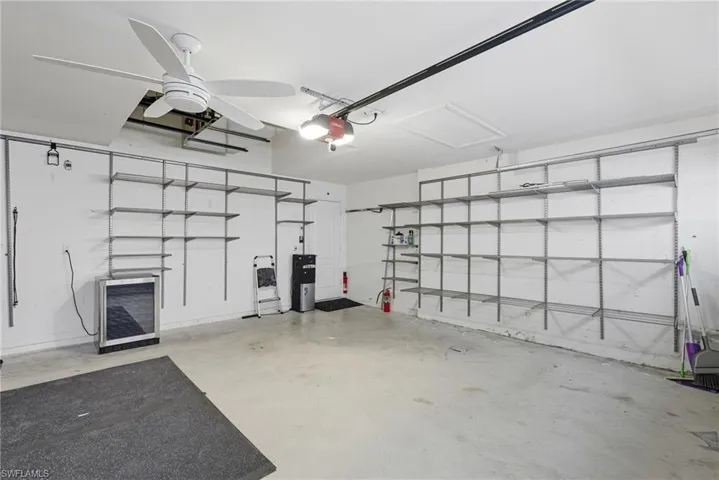 Garage with Custom 2-Car Garage with Shelving and Smart Garage Door Opener