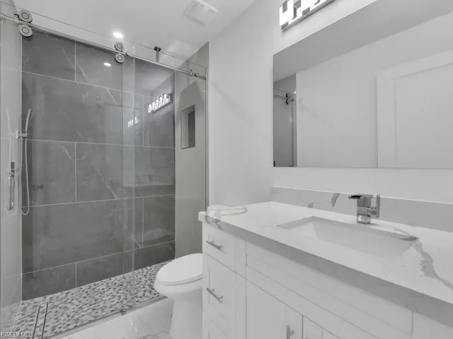 Bathroom featuring vanity and a shower stall