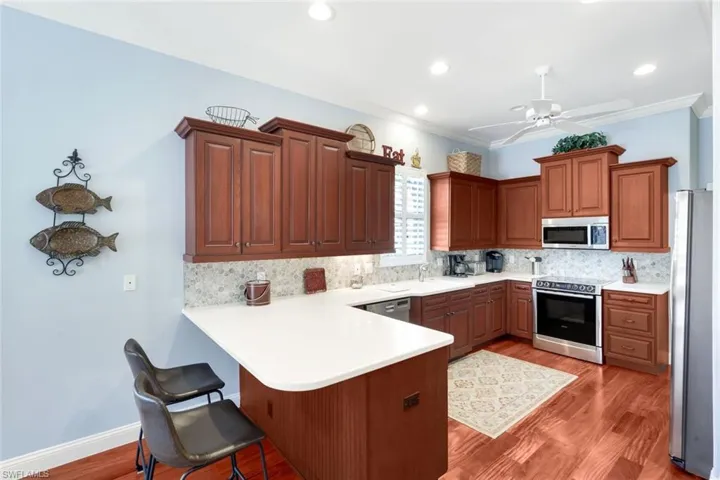 Dining space featuring ornamental molding, wood finished floors, and recessed lighting