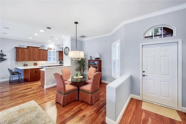 Community pool with a patio area and golf course view