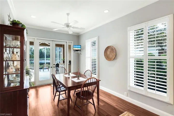 Dining area featuring french doors, crown molding, wood finished floors, ceiling fan, and recessed lighting