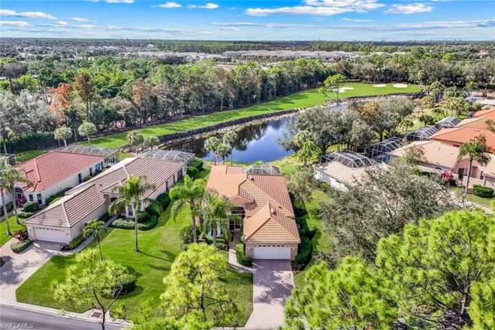 View of home's community featuring a water view, view of scattered trees, and golf course view