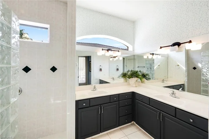 Carpeted bedroom featuring baseboards and a ceiling fan
