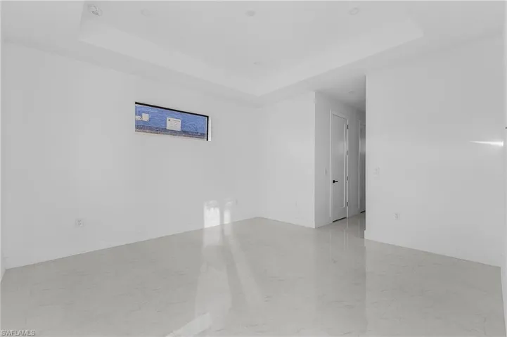 Unfurnished room featuring a tray ceiling