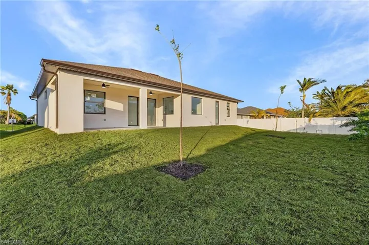Back of house featuring ceiling fan, stucco siding, and a patio