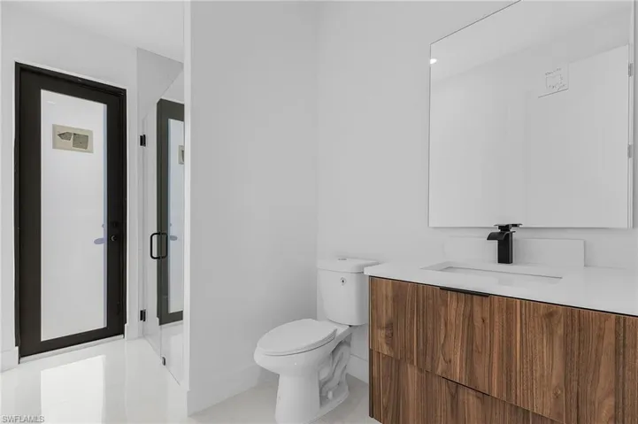 Bathroom featuring vanity, a shower stall, and light tile patterned flooring