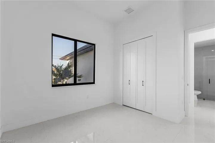 Unfurnished bedroom featuring a closet and ensuite bathroom