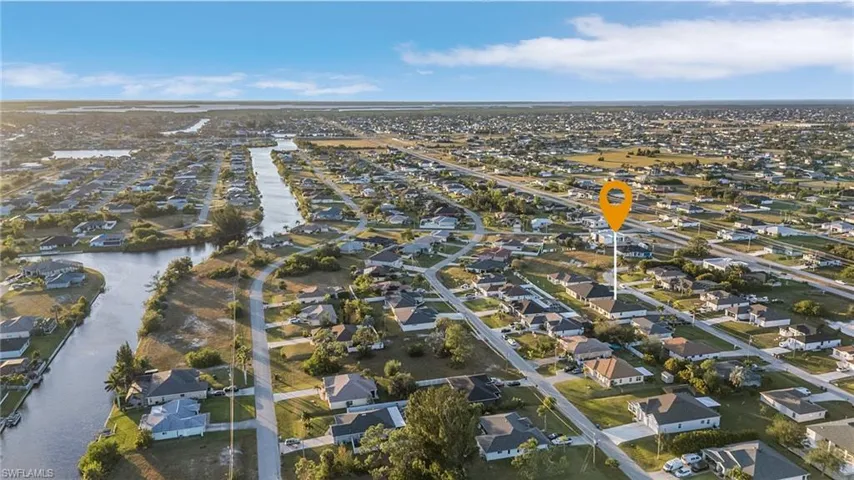 Aerial overview of property's location featuring nearby suburban area and a nearby body of water