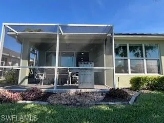 Rear view of property featuring a sunroom