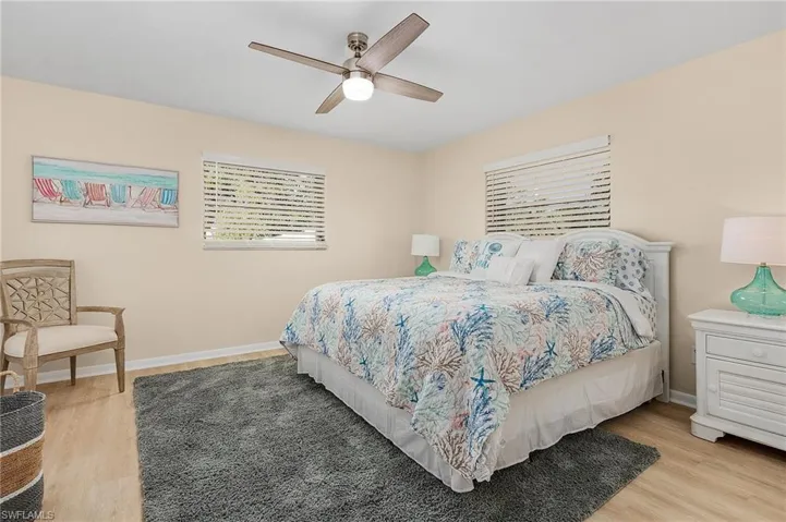 Bedroom with ceiling fan and light wood-type flooring