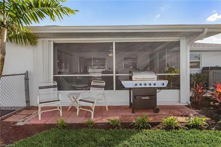 View of patio / terrace featuring cooling unit, grilling area, and a sunroom
