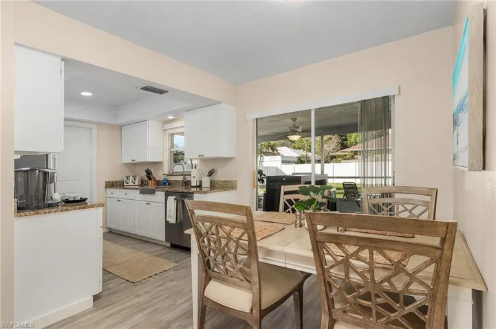 Dining area with light hardwood / wood-style floors, sink, and ceiling fan