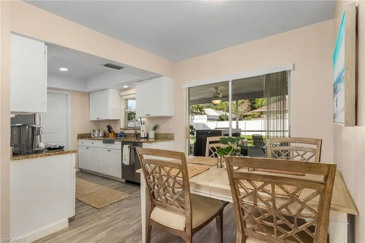 Dining area with light wood-type flooring, sink, and ceiling fan
