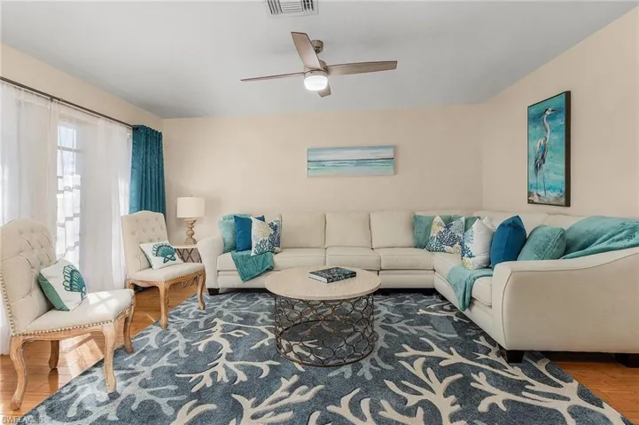 Living room featuring ceiling fan and hardwood / wood-style floors