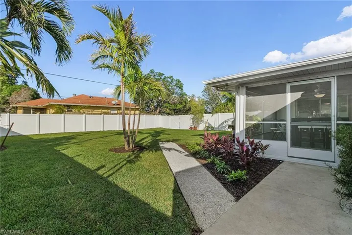 View of yard featuring a sunroom
