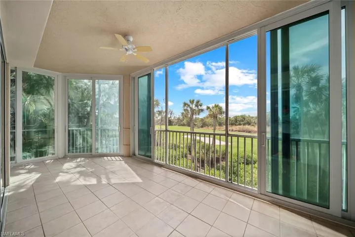 Unfurnished sunroom with ceiling fan and plenty of natural light
