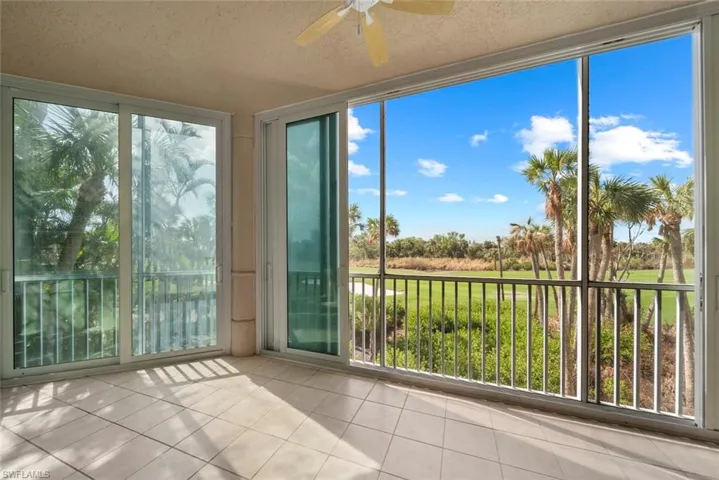 Unfurnished sunroom with ceiling fan and plenty of natural light