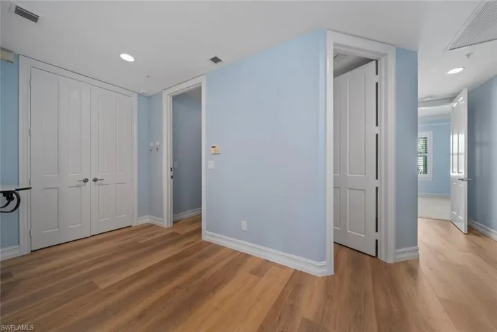 Unfurnished bedroom featuring hardwood / wood-style flooring and a closet